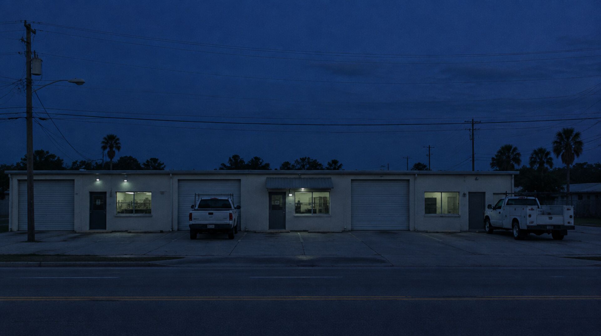 A row of small independent businesses on a Florida street at dusk